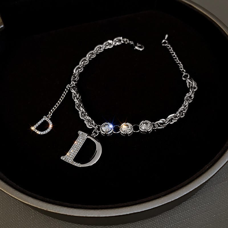 BROOCHITON Bracelets top view of a Silver Diamond Letter D Fringe Chain Bracelet on a black background