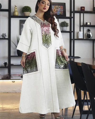a woman wearing a white dubai beads sequin embroidered robe full length view