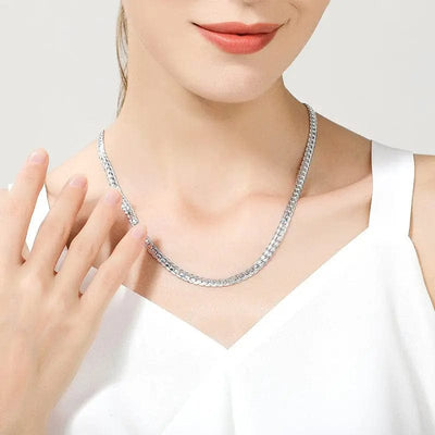 a woman wearing a silver Snake chain necklace