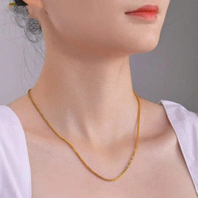a woman wearing a woven chain couple necklace