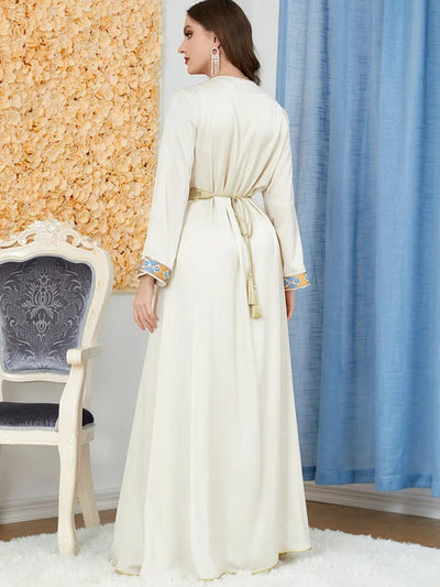 a woman wearing a Beige women's arabian dress slit v-neck full length back view