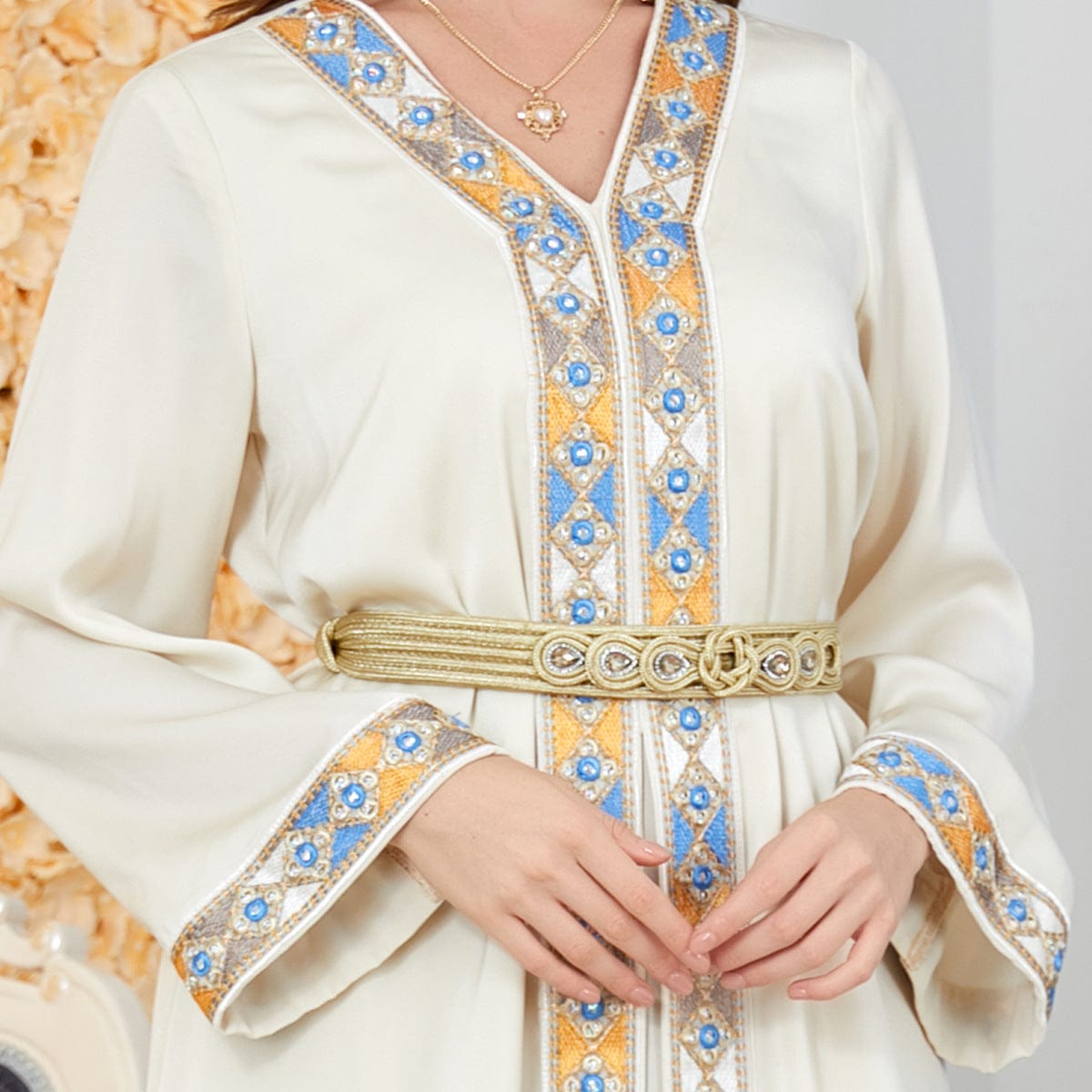 a woman wearing women's arabian dress slit v-neck beige color front close up view