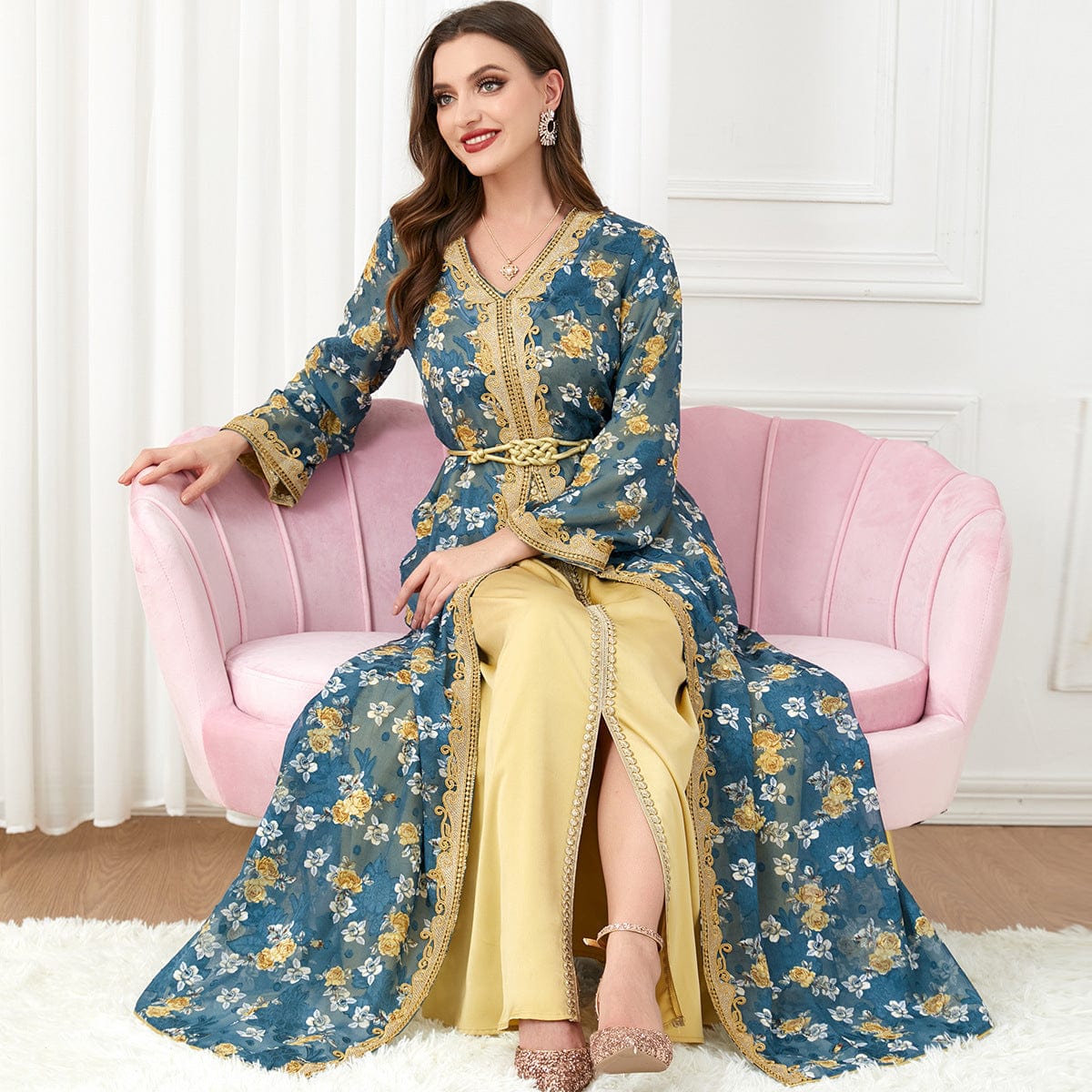 a woman wearing a floral green / 2XL women's arabic clothing fashion robe sitting on pink couch