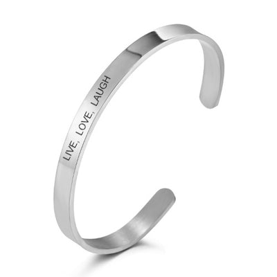 Silver bangle with 'LIVE. LOVE. LAUGH' engraving on a white background