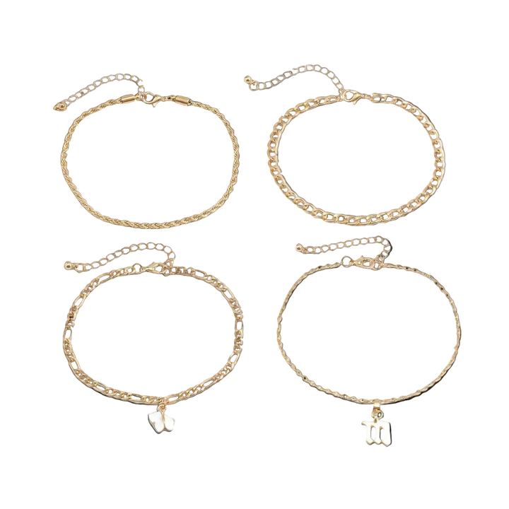 Set of four gold chain bracelets with small charms on a white background
