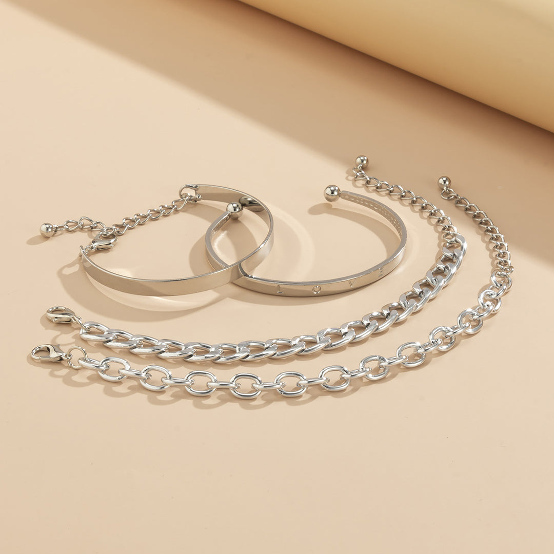 Set of silver bracelets on a beige background