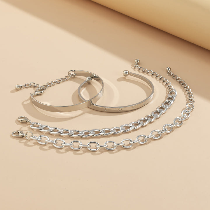 Set of silver bracelets on a beige background