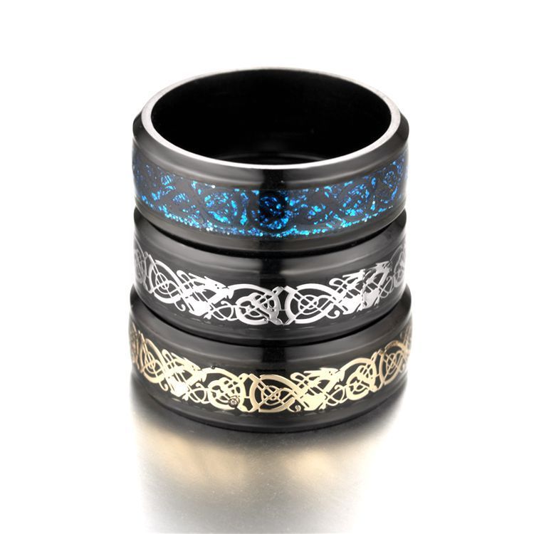 Stack of black rings with blue, white, and gold designs on a white background