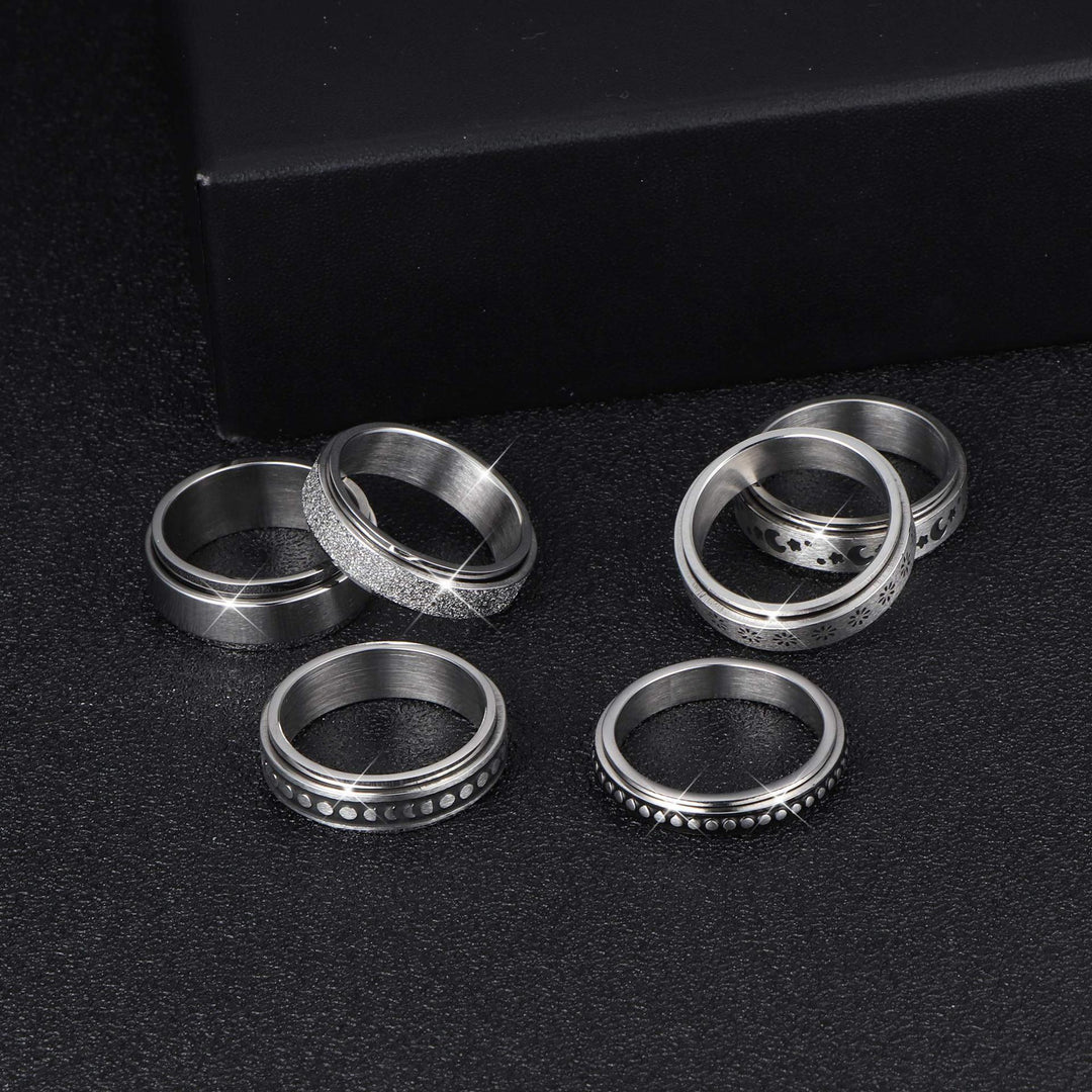 Set of silver rings on a black background