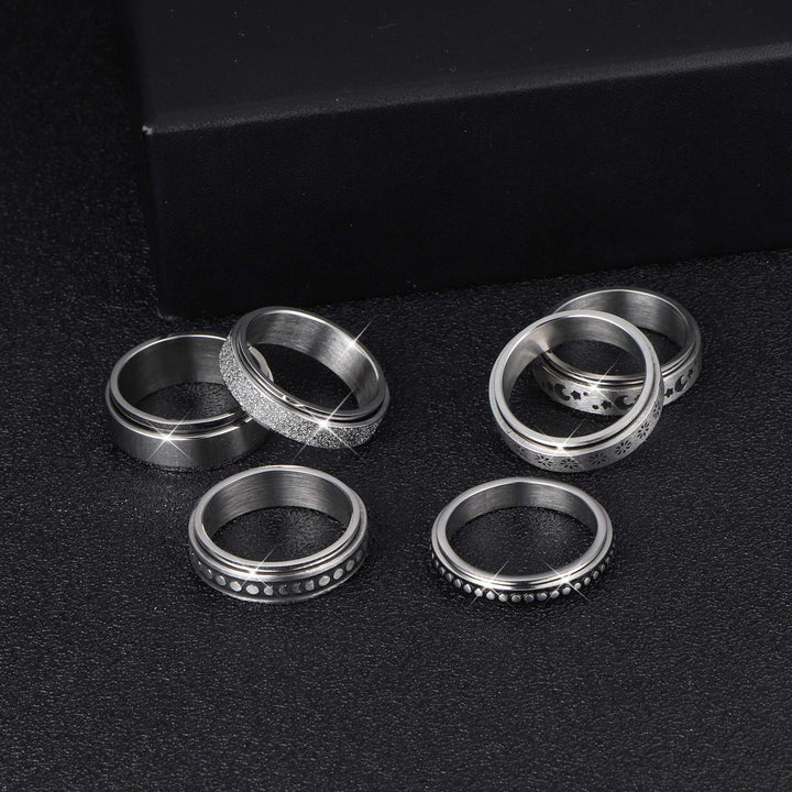 Set of silver rings on a black background