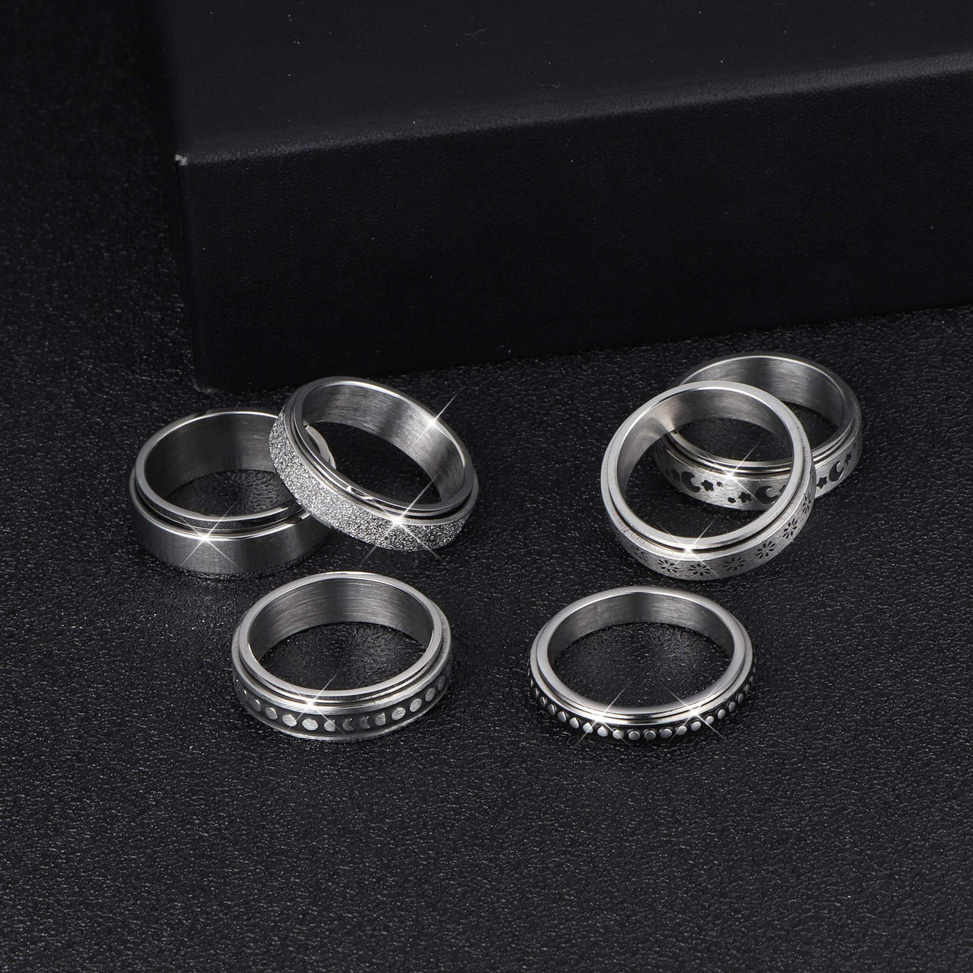 Set of silver rings on a black background