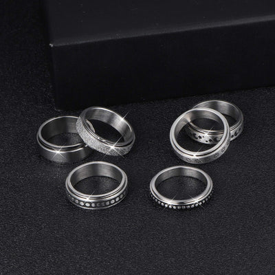 Set of silver rings on a black background