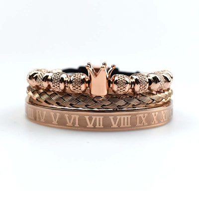 Rose gold ring with crown design and Roman numeral engraving on a white background