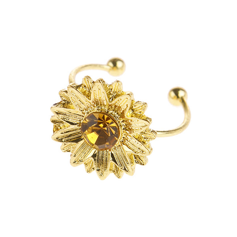 Gold nose ring with a central gemstone on a white background