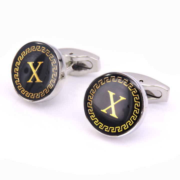 Cufflinks with black and gold design on a white background