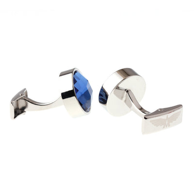 Silver cufflinks with blue gemstones on a white background