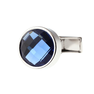 Cufflink with blue gemstone and silver metal on a white background