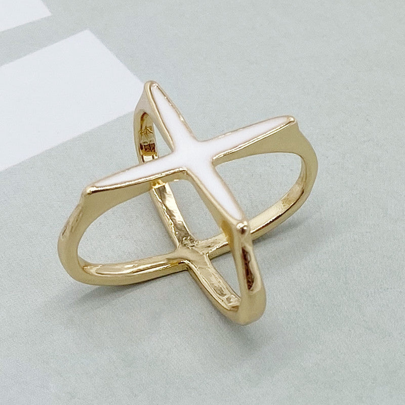 Gold ring with a star design on a light gray background