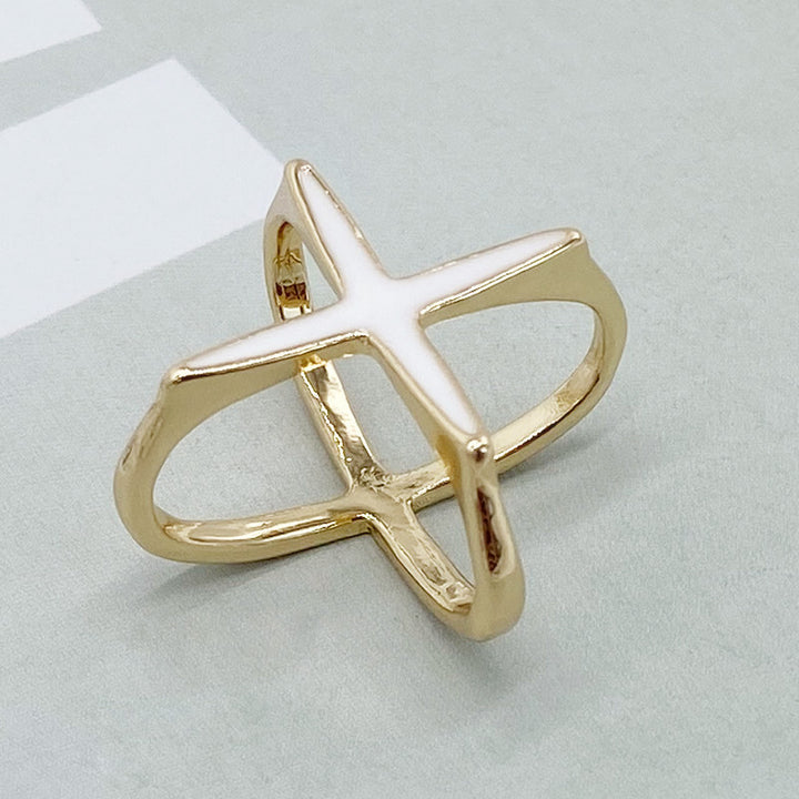 Gold ring with a star design on a light gray background