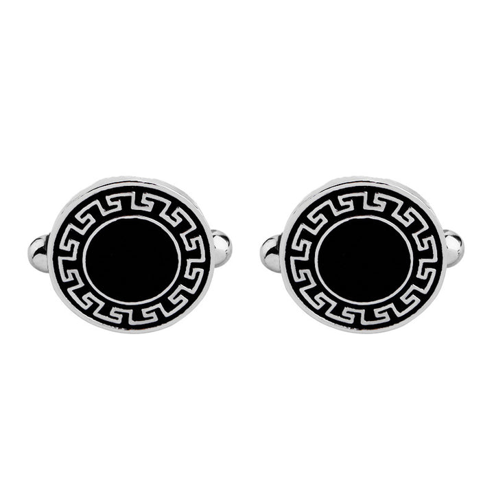 Round cufflinks with black center and silver border on a white background