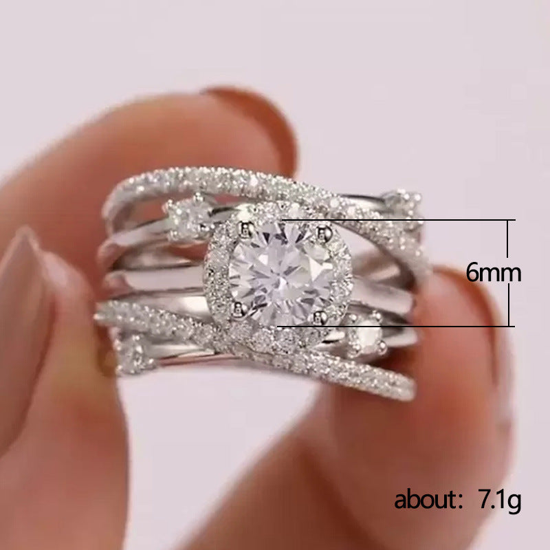 Silver ring with zircon held by a hand, showing size and weight details.