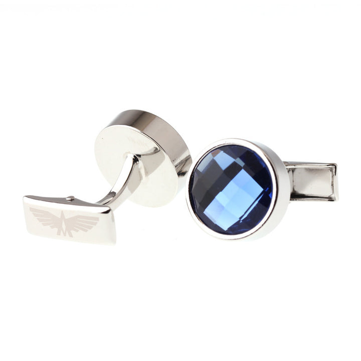 Silver cufflinks with a blue gemstone on a white background