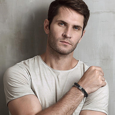 Man wearing a white t-shirt against a gray background