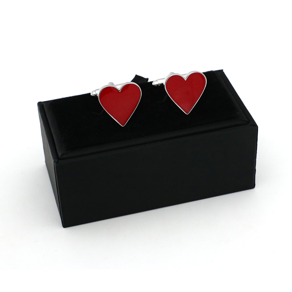 Red heart-shaped cufflinks in a black box on a white background