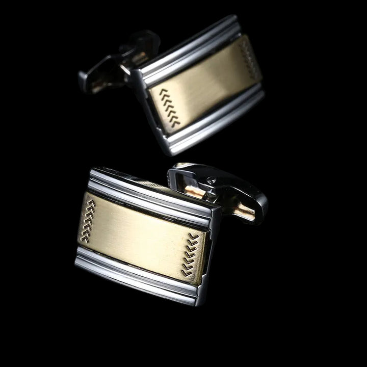 Gold and silver cufflinks with a black background