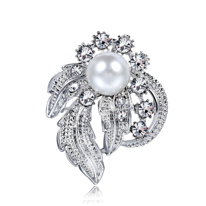 Elegant brooch with pearl and crystals on a white background