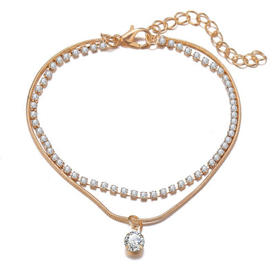 Rose gold anklets with diamond accents on a white background
