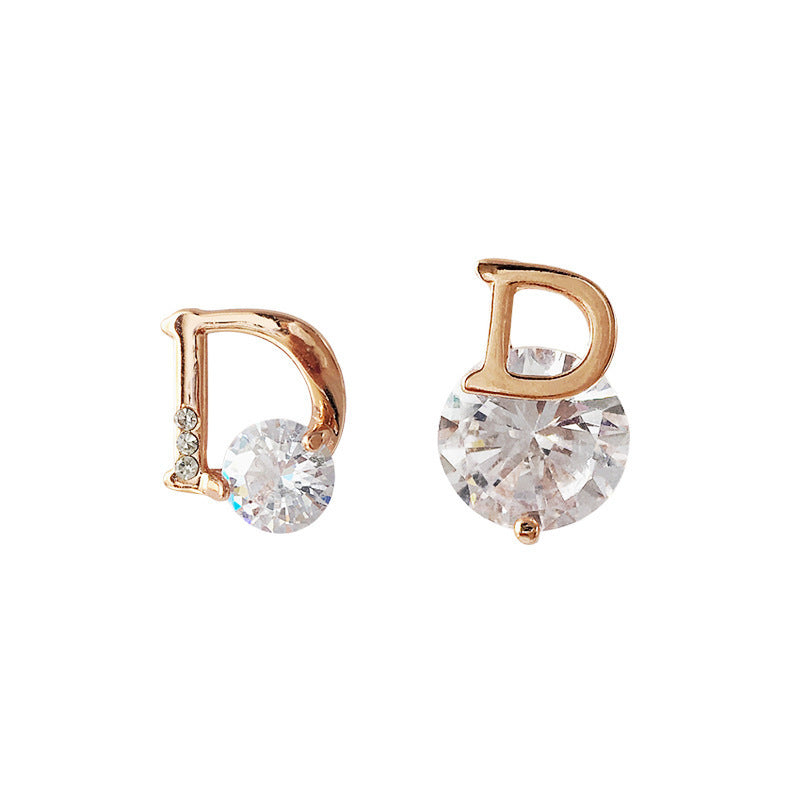Rose gold hoop earrings with clear gemstones on a white background