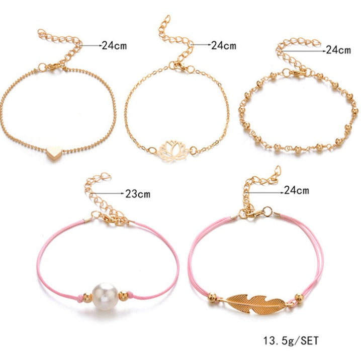 Set of gold and pink bracelets with measurements on a white background