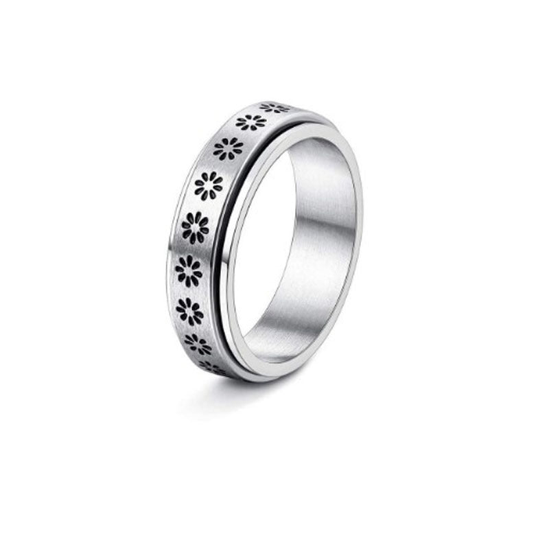 Silver ring with floral cut-out design on a white background