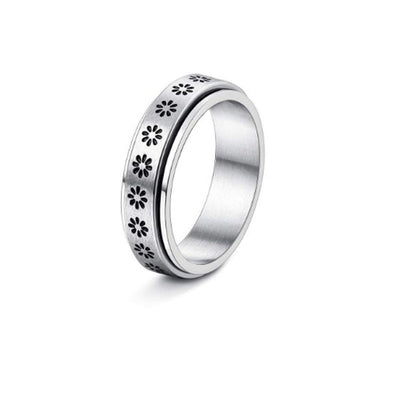 Silver ring with floral cut-out design on a white background