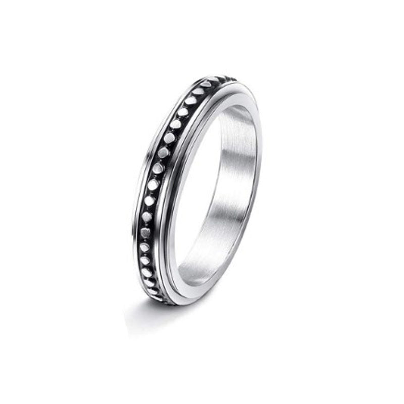 Silver ring with a textured band on a white background