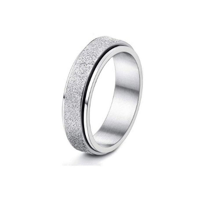 Silver ring with textured band on a white background