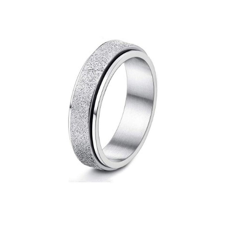 Silver ring with textured band on a white background