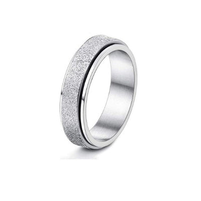 Silver ring with textured band on a white background
