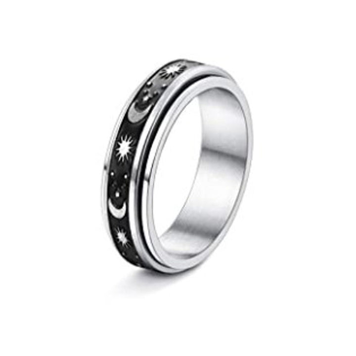 Silver ring with star and moon design on a white background