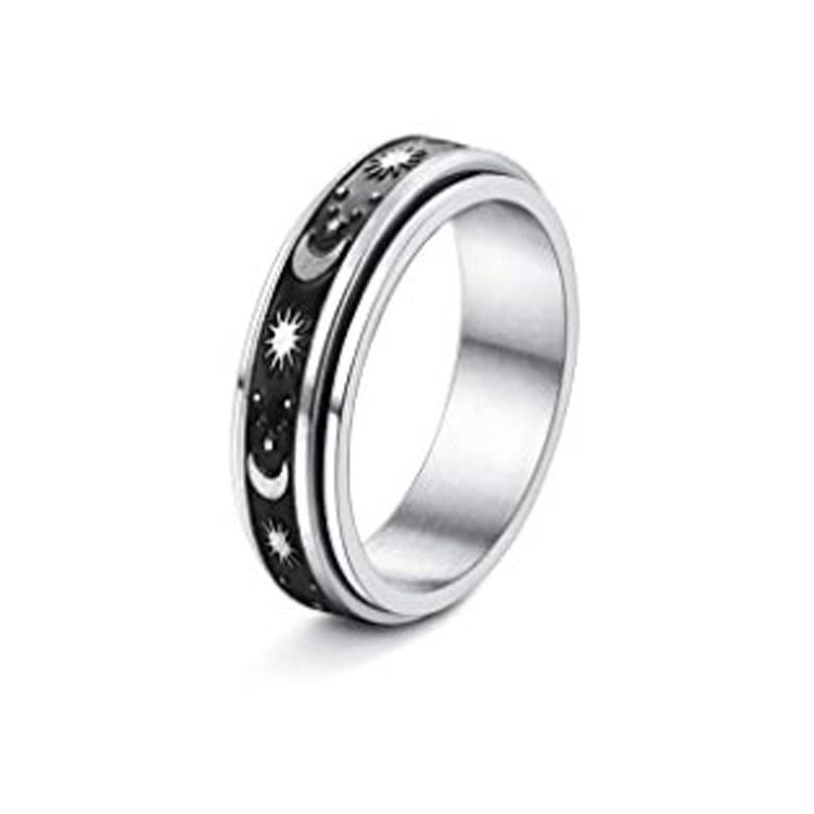 Silver ring with star and moon design on a white background