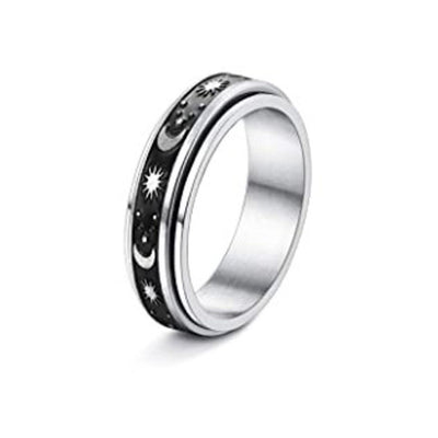 Silver ring with star and moon design on a white background