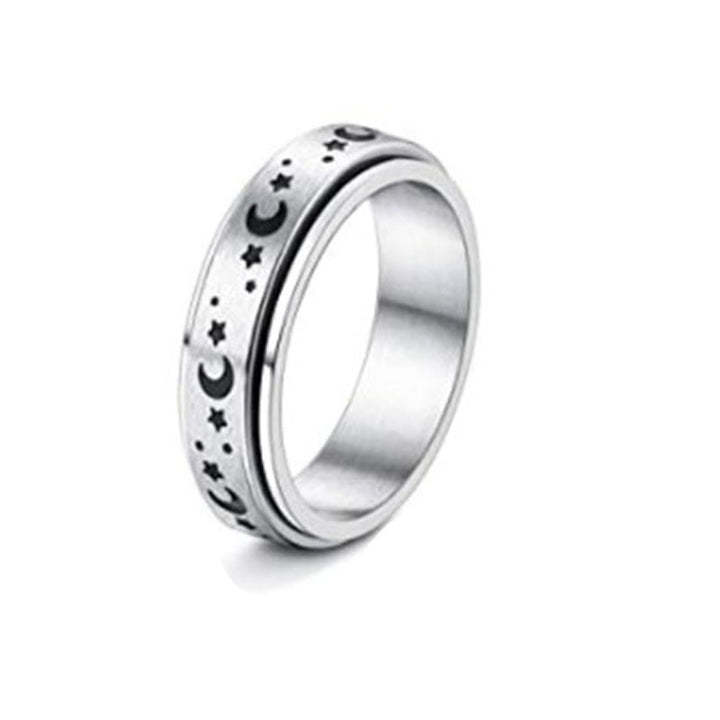 Silver ring with star and moon designs on a white background