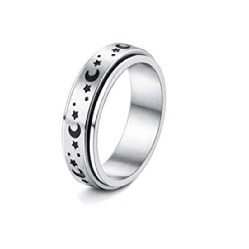 Silver ring with star and moon designs on a white background