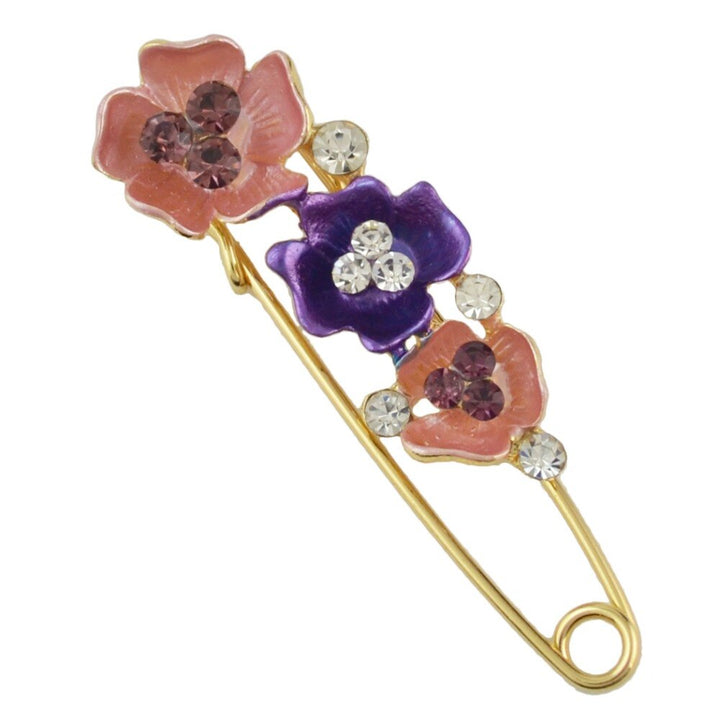 Decorative brooch with floral designs and crystals on a white background