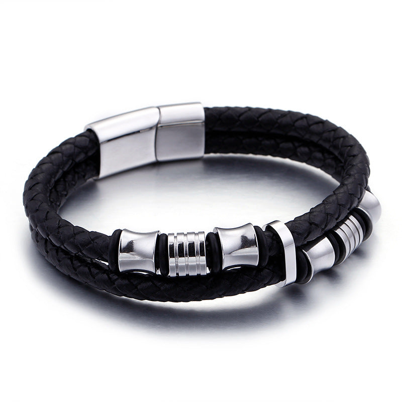 Black braided leather bracelet with silver metal accents on a white background