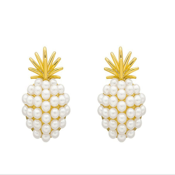 Pineapple-shaped earrings with pearl details on a white background