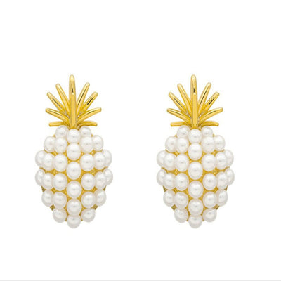Pineapple-shaped earrings with pearl details on a white background