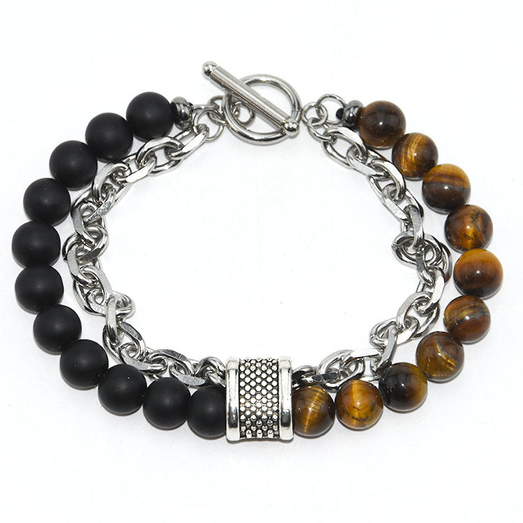 Bracelet with black and brown beaded links on a white background