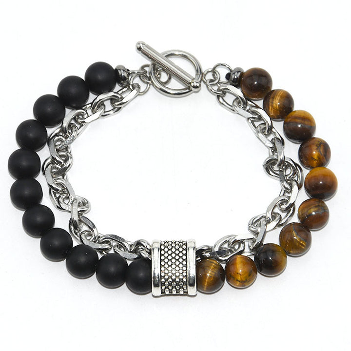 Bracelet with black and brown beaded links on a white background